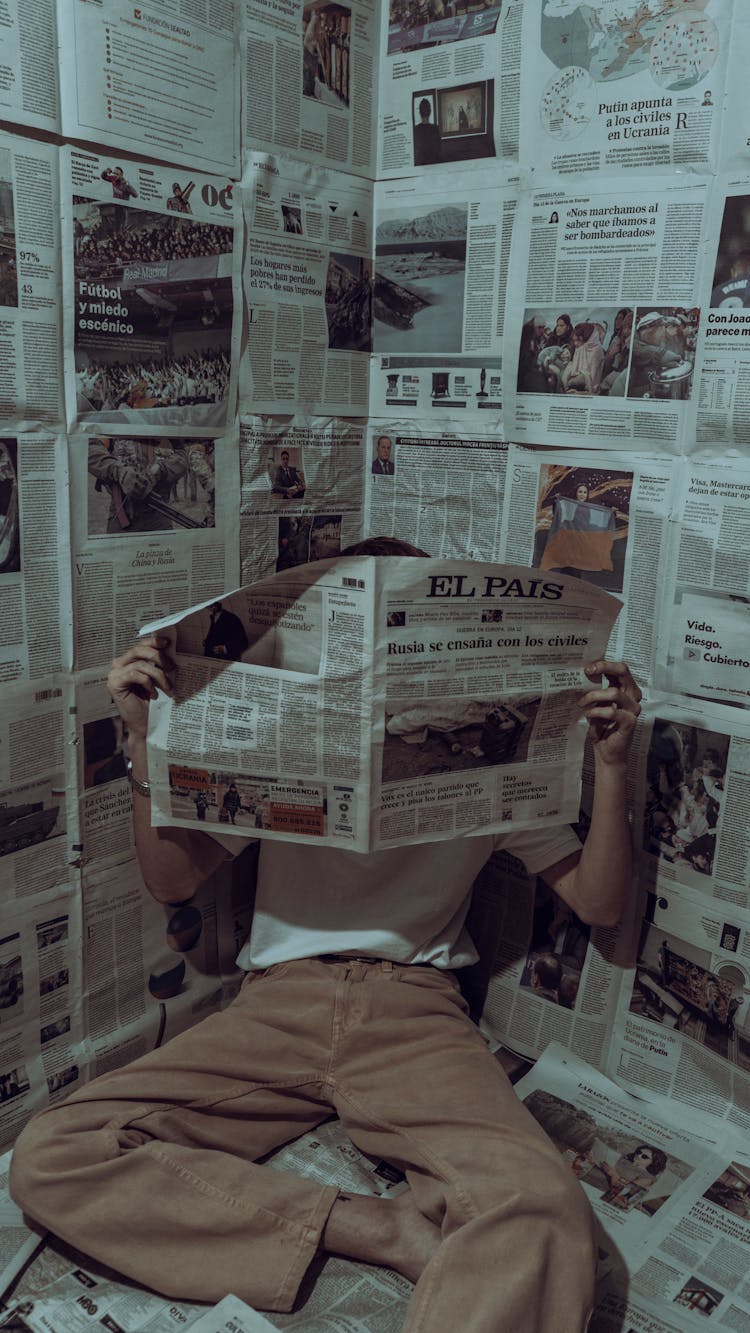 Unrecognizable Person Reading Newspaper