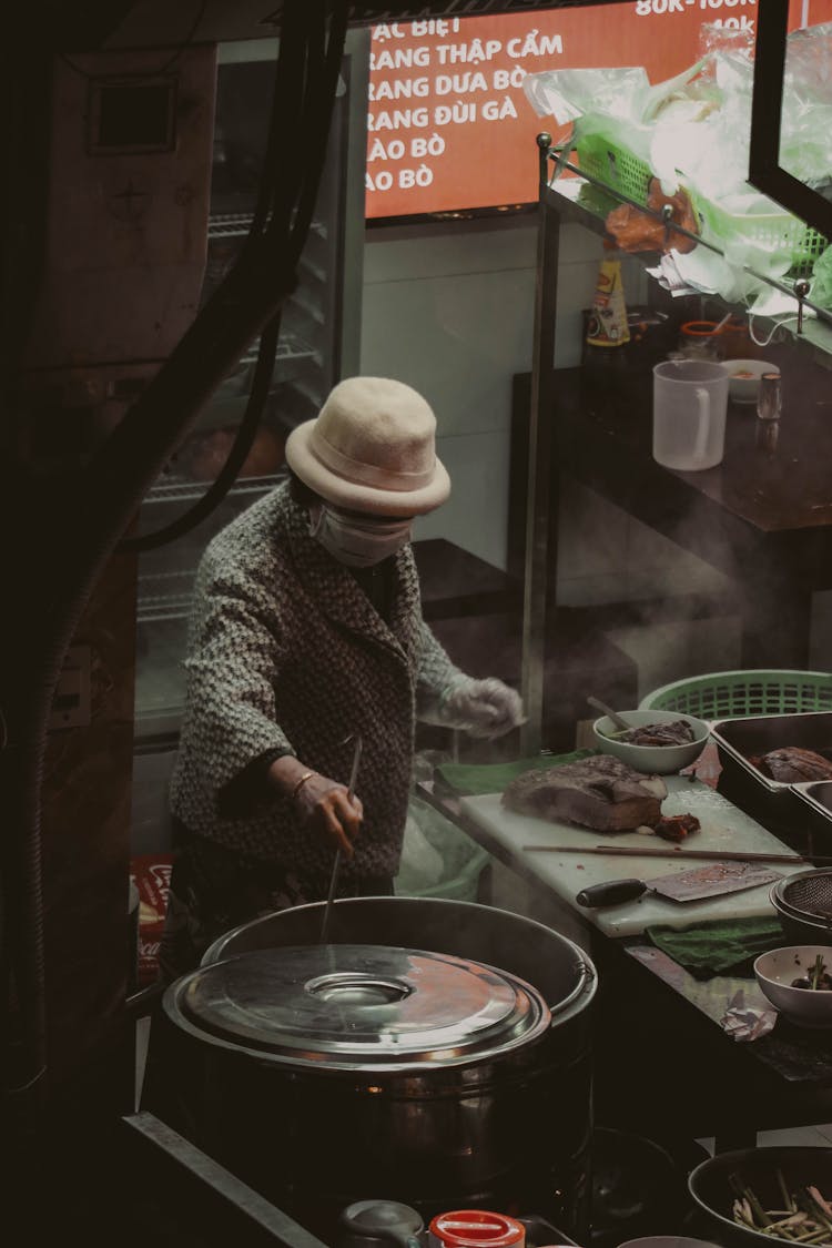 Woman Working On A Food Stall