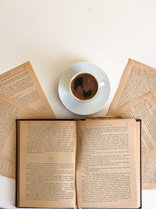 Free Black Coffee in White Cup and Old Books Stock Photo