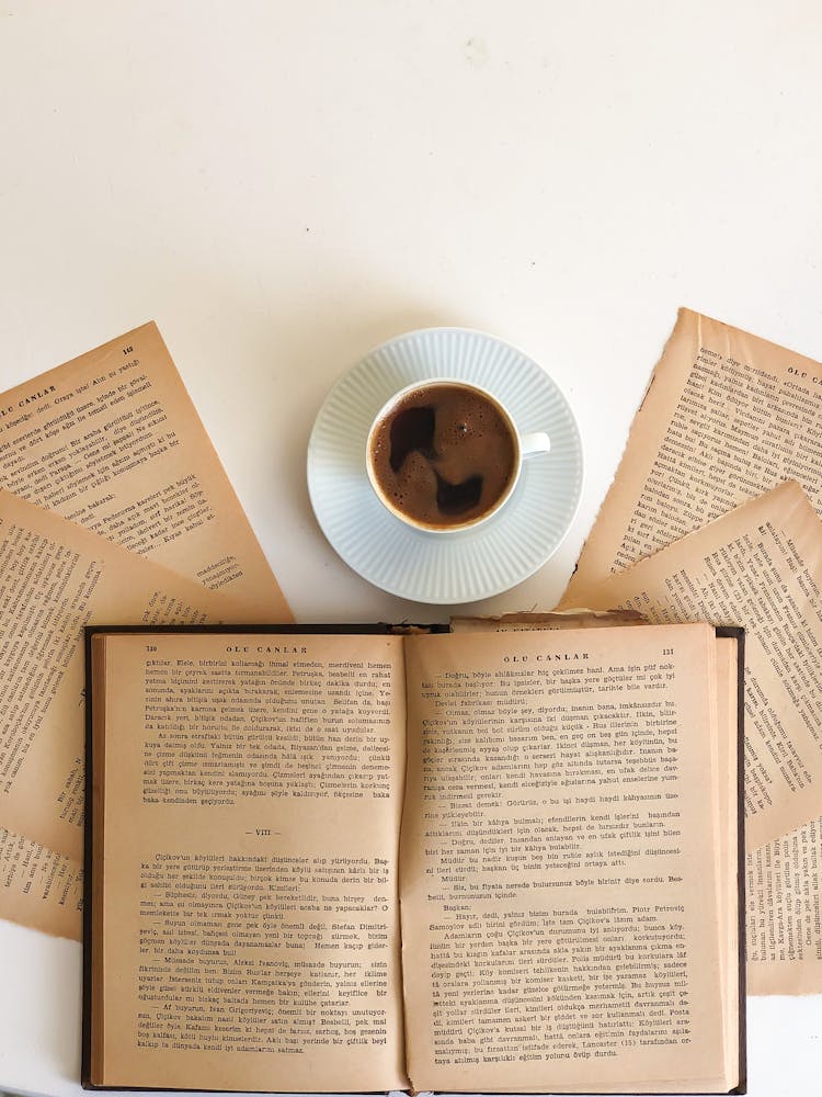 Black Coffee In White Cup And Old Books