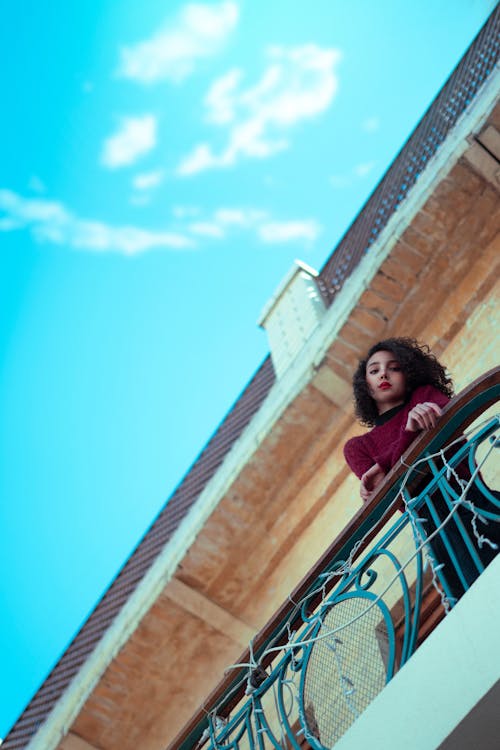 Beautiful Woman on Balcony Looking Down