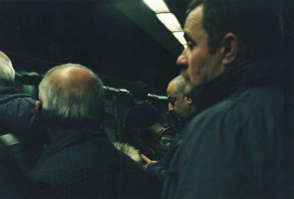 A group of commuters waiting at an underground station in Istanbul, Turkey.