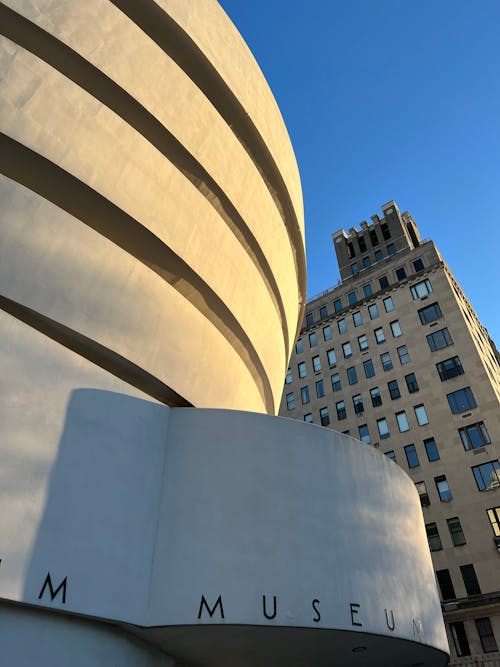 Low-Angle Shot of a White Concrete Building in the City