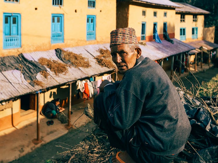 Man Crouching On Rooftop