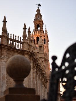 Iconic Giralda Tower viewed at twilight, highlighting its historic architecture in Seville, Spain.
