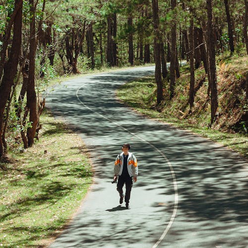 Man Walking Alone on the Road 