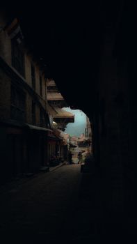 Dark and intriguing urban alleyway with mysterious atmosphere, capturing city shadows and architectural details.