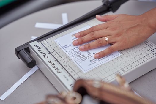 Person Cutting Paper with a Paper Guillotine