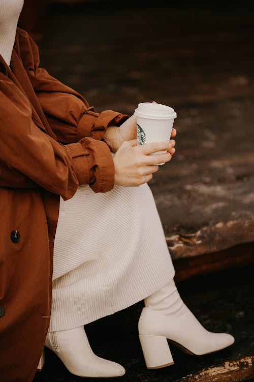 Free Woman Sitting and Holding Starbucks Cup  Stock Photo