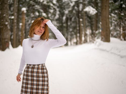 Free Woman Wearing a White Turtleneck Sweater and Plaid Skirt Stock Photo