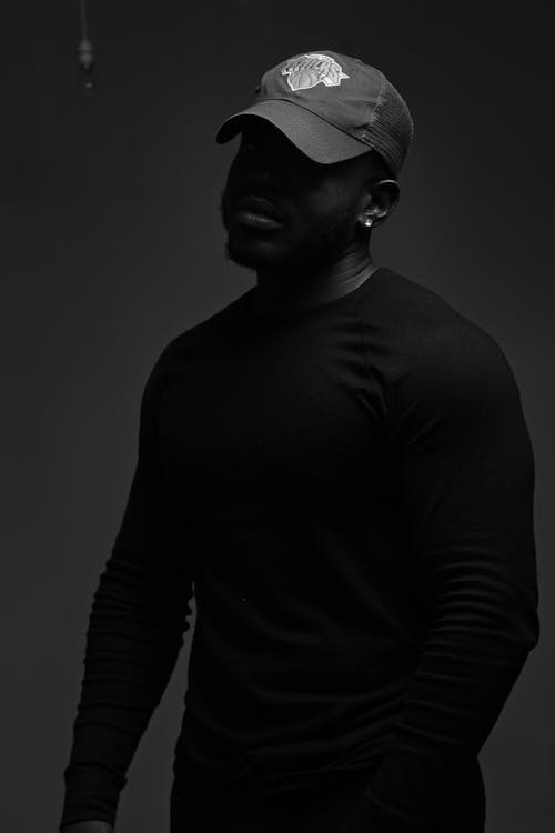 Man in Black Long Sleeve Shirt Wearing a Cap