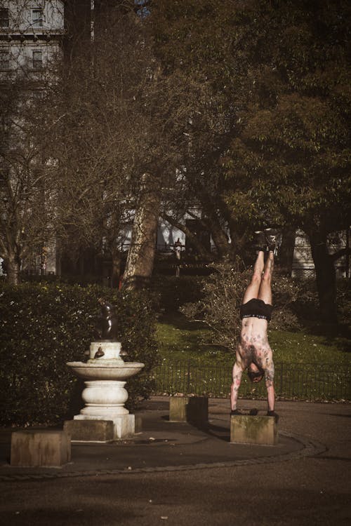 Shirtless Man Doing a Handstand
