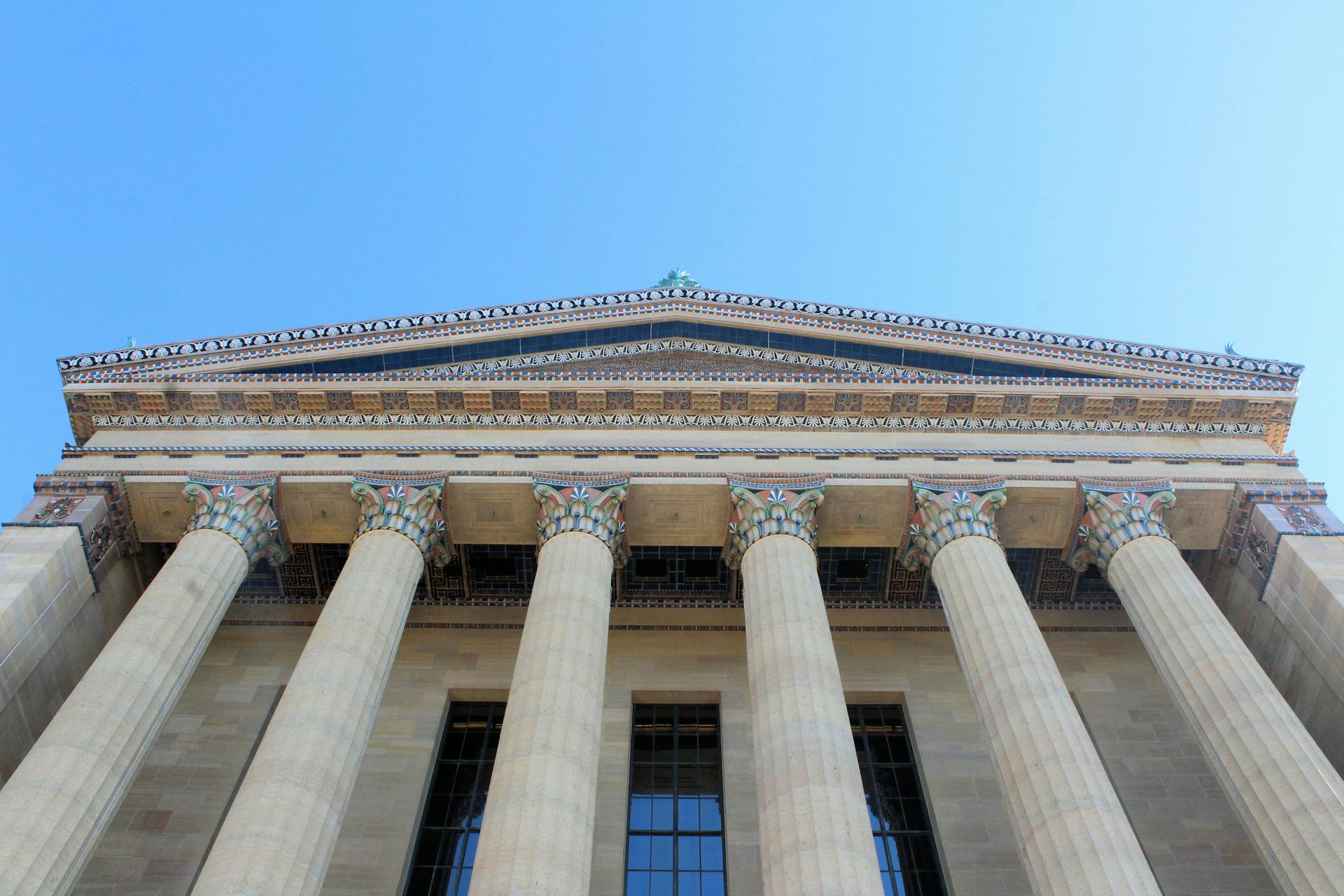 Low angle view of the Philadelphia Museum of Art's facade under a clear blue sky.