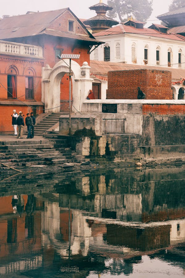 Reflections of People and Buildings on Water Surface