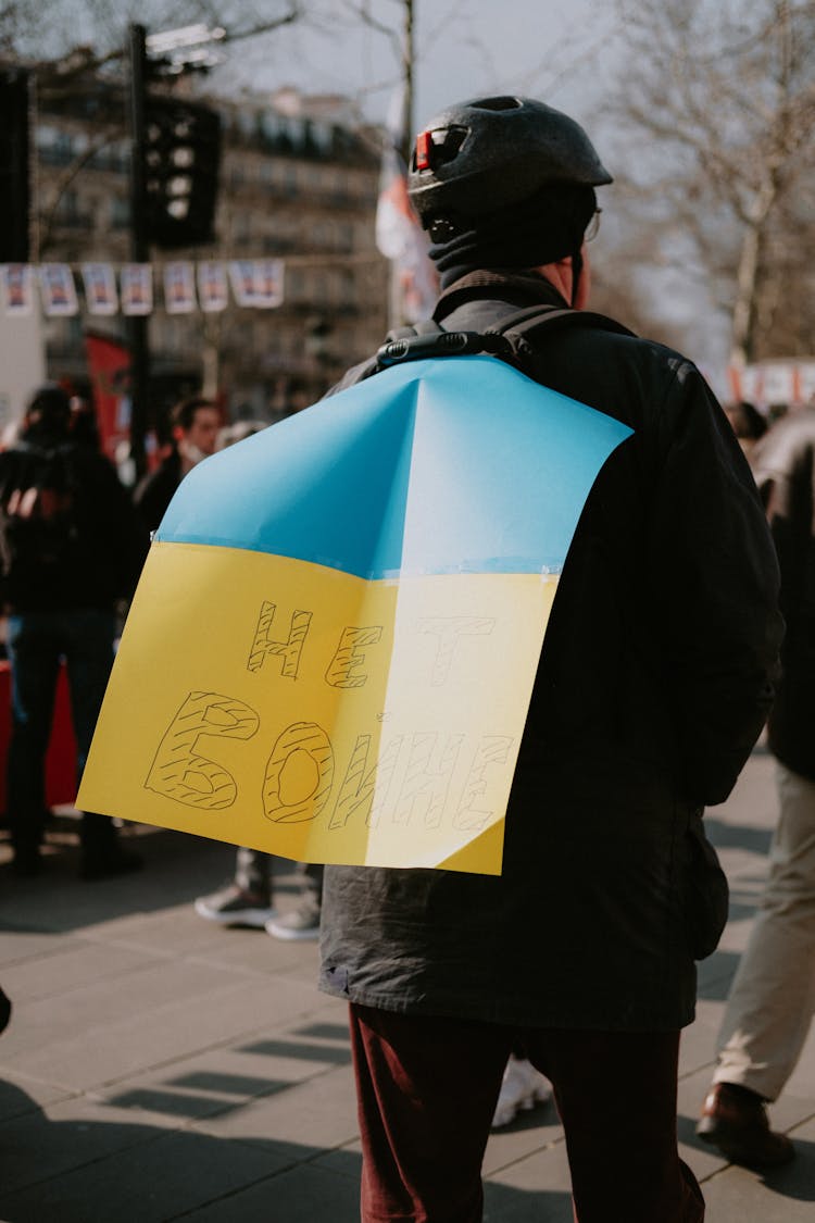 Back View Of A Protester With Poster On Its Back