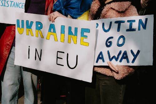 People Holding Posters 