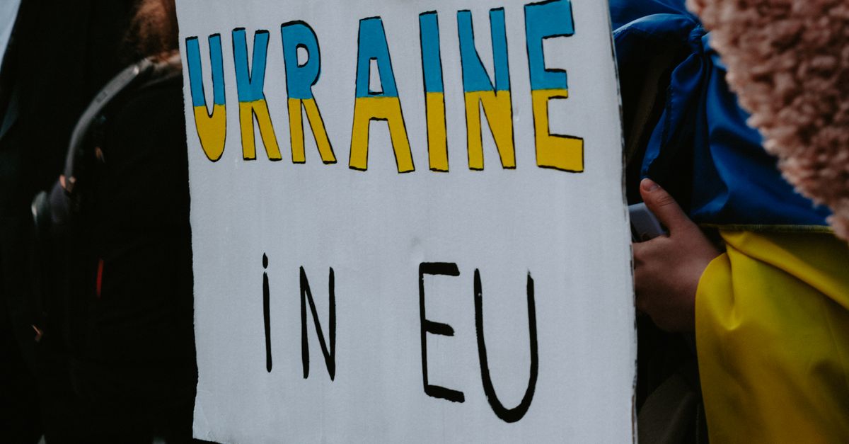 A protest sign advocating Ukraine's membership in the EU, held by demonstrators outdoors.