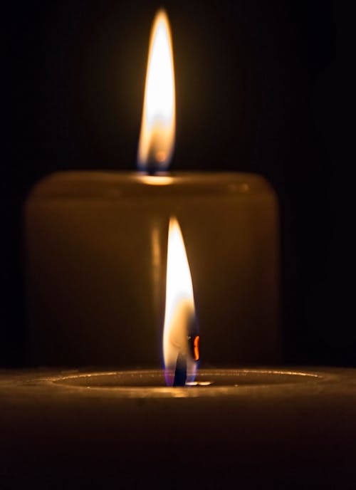 Two Candles Burning In the Darkness