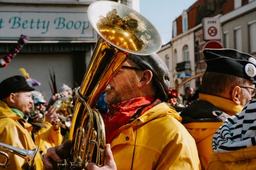 Free Colorful street parade featuring musicians in vibrant costumes playing brass instruments. Stock Photo