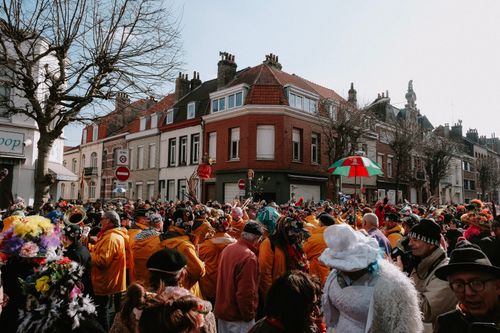 Free Vibrant street parade with people in colorful costumes in a European city. Stock Photo