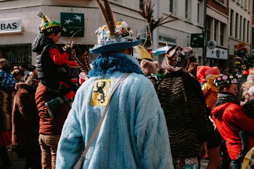 Free Lively street parade with people in vibrant costumes celebrating a traditional festival. Stock Photo