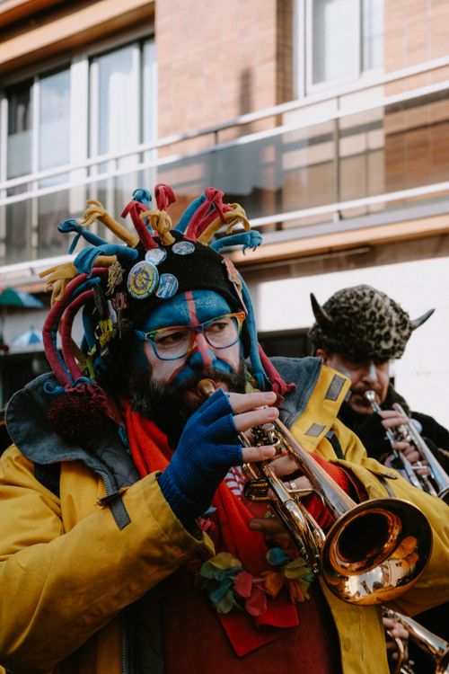 Free Colorful street performers playing trumpets during festive parade. Captivating and lively atmosphere. Stock Photo