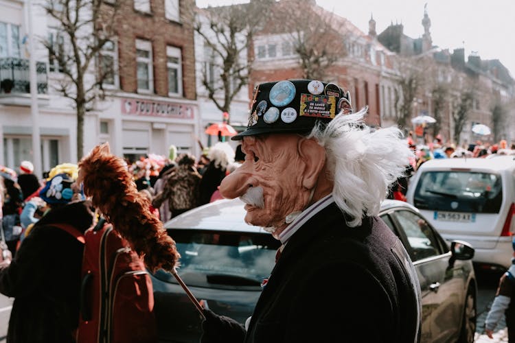 Person Wearing A Mask And Holding A Duster