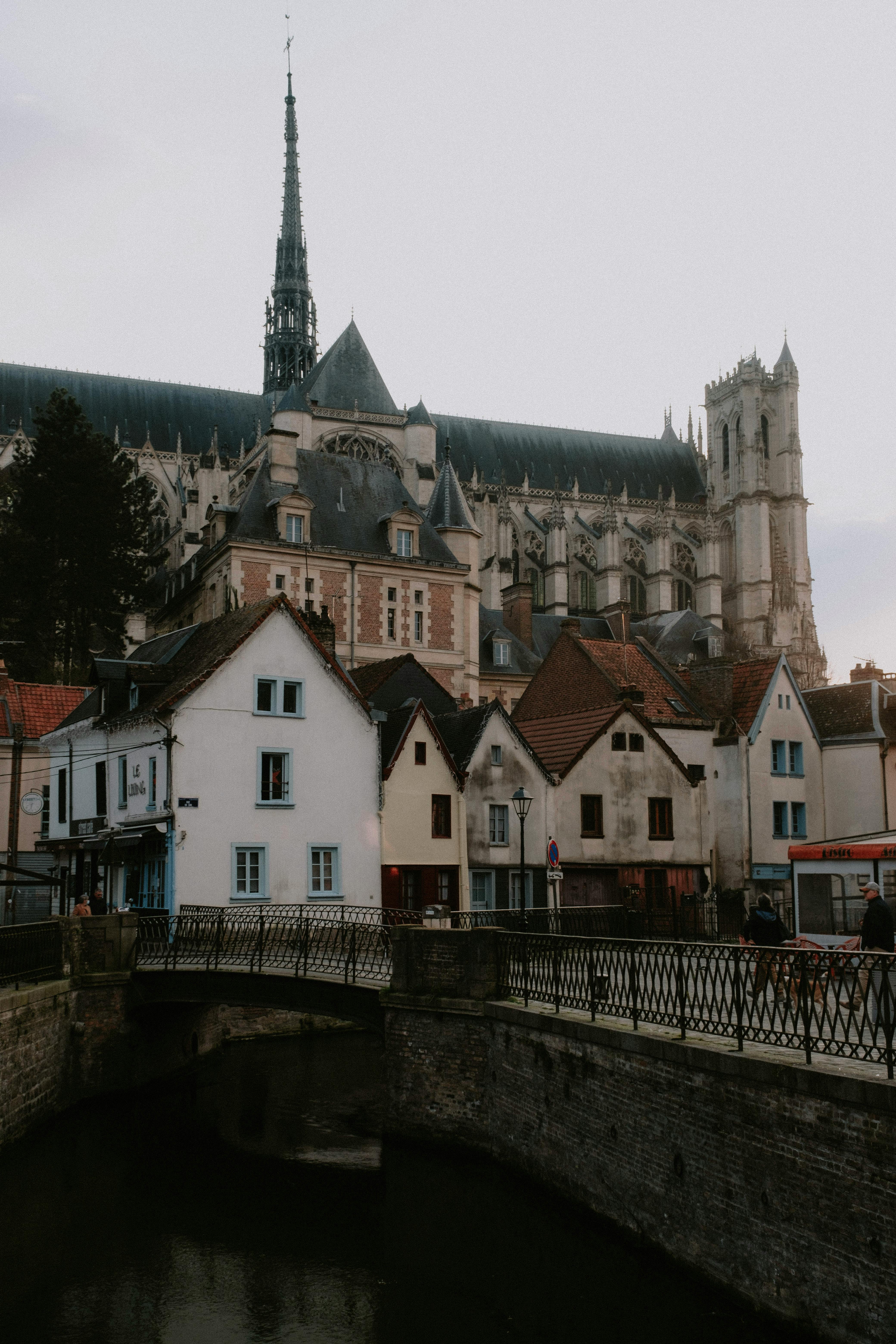 View of Amiens Cathedral with charming residential buildings in France.