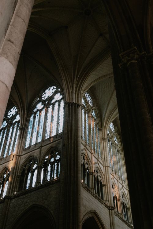 Free Gothic cathedral interior featuring stunning stained glass windows and arches. Stock Photo