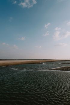 A serene coastal scene with gentle waves and a clear blue sky, perfect for nature enthusiasts.