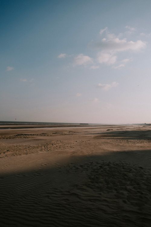 Free Peaceful sandy beach with clear blue sky, perfect for a tranquil escape. Stock Photo