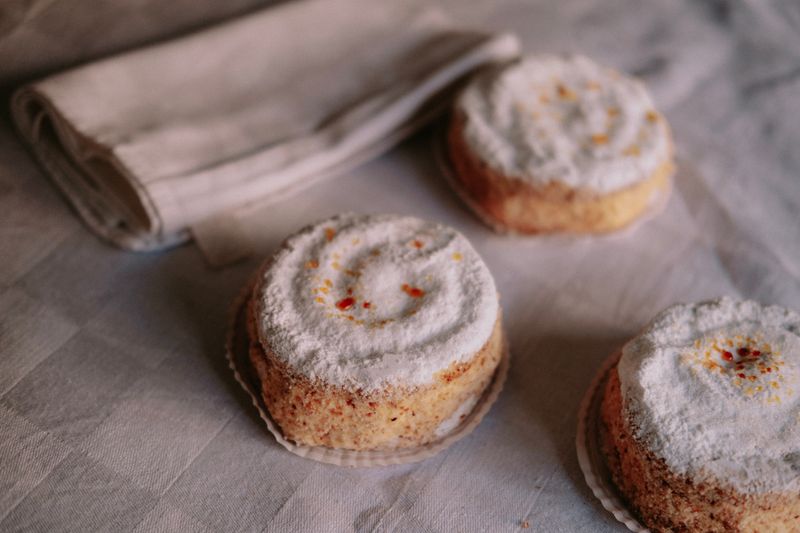 Sugar-dusted small cakes on a linen cloth — photo by Mathias Reding on Pexels