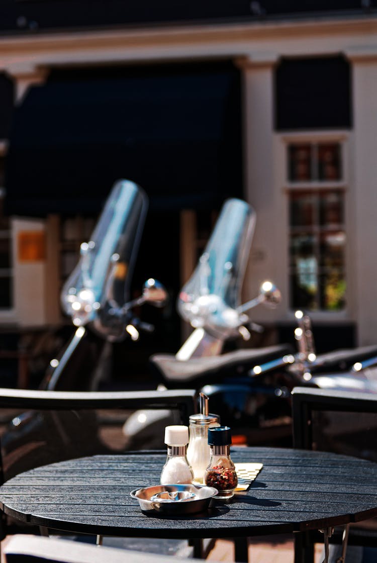 Condiments On Black Wooden Table