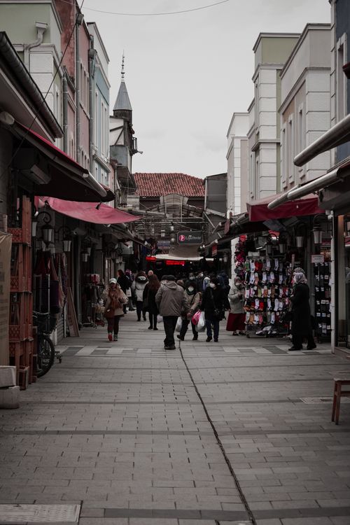 Free A lively street market with people shopping amidst vibrant storefronts. Stock Photo