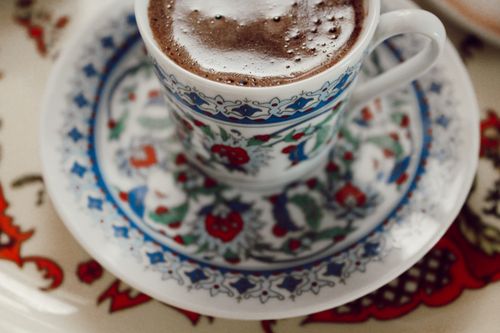 Free Close-up of a foamy Turkish coffee in a beautifully designed porcelain cup on a saucer. Stock Photo