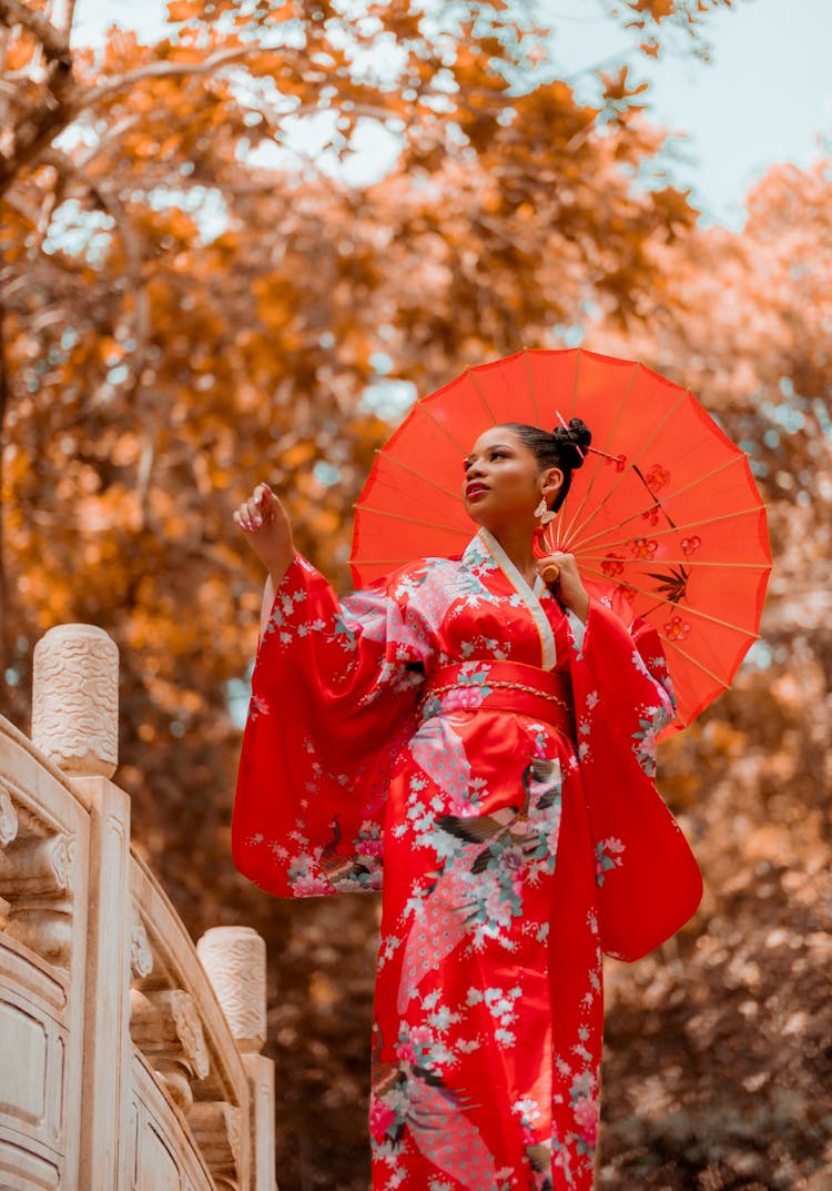 Woman In Red Kimono Holding An Umbrella