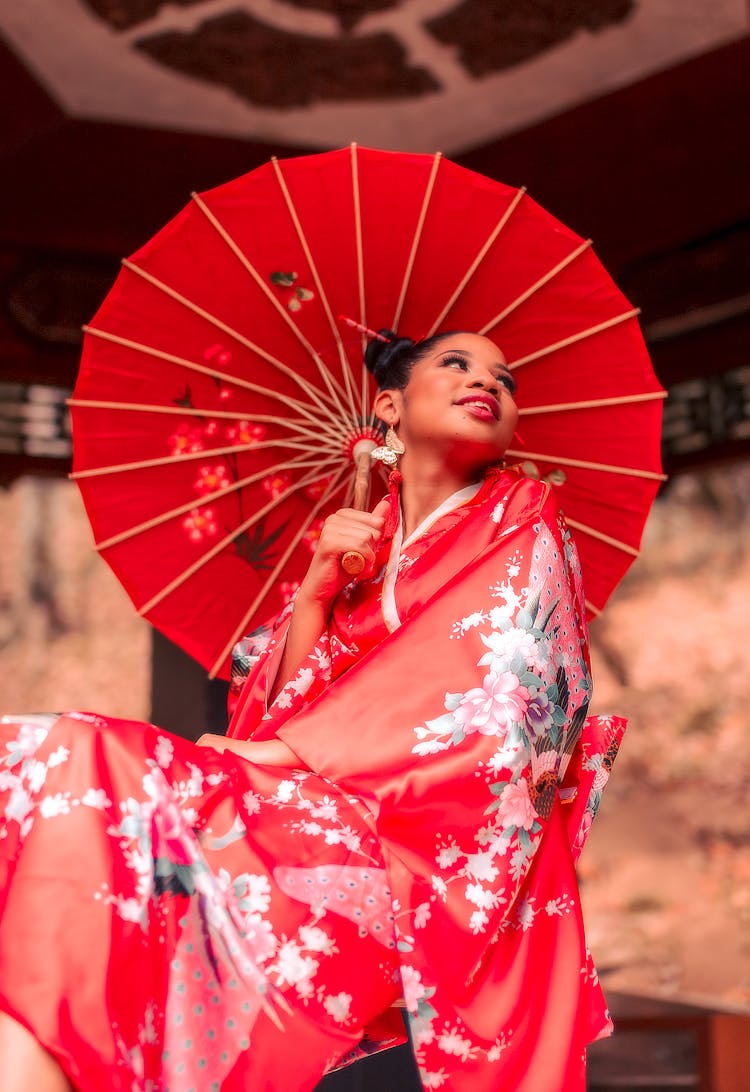 Woman In Red Kimono Holding An Umbrella