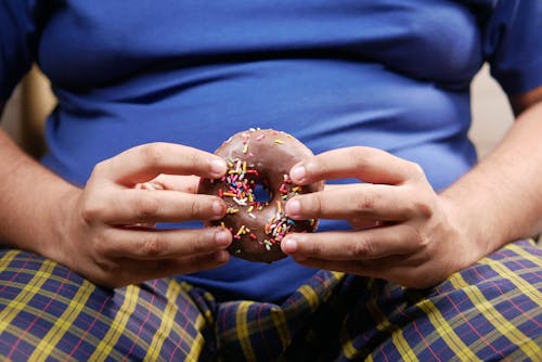 Person Holding a Doughnut