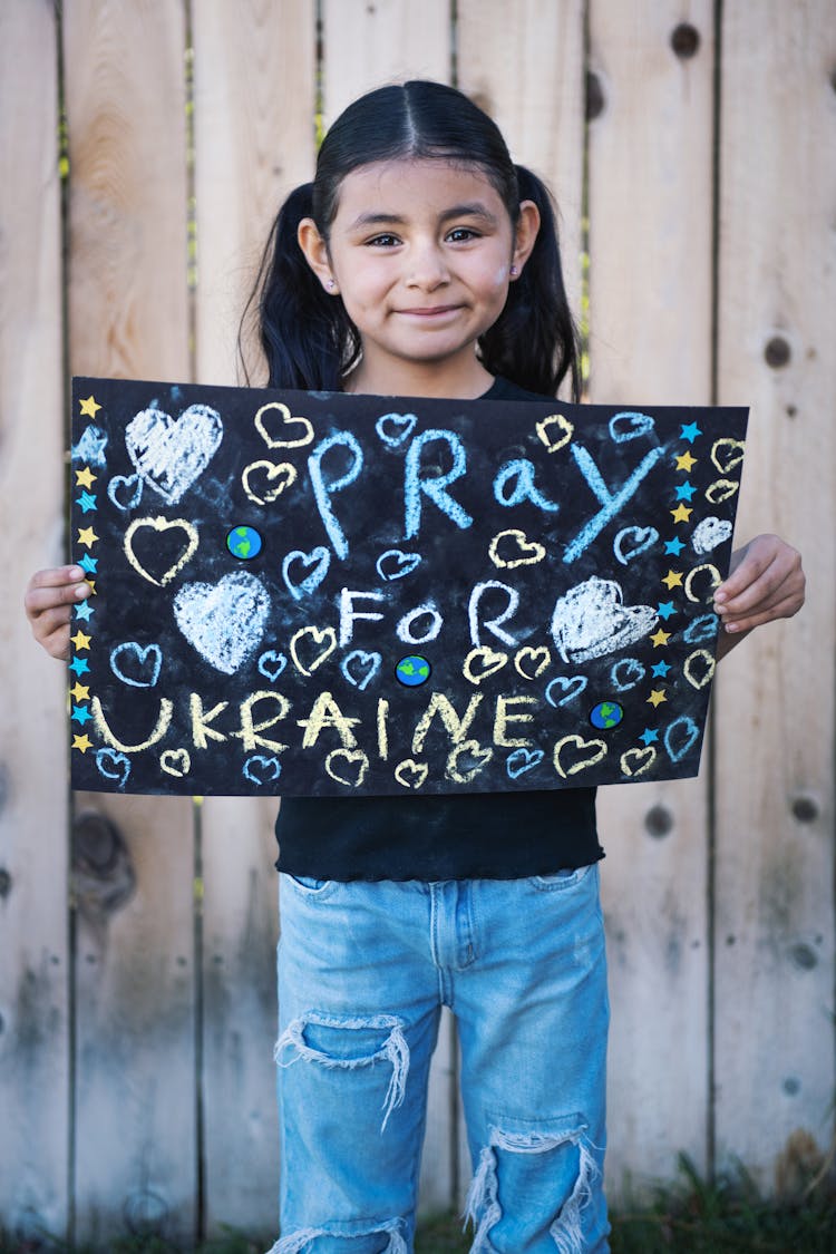 Girl Holding Political Slogan Placard