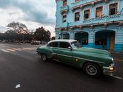 A Vintage Pontiac Chieftain Driving on Road