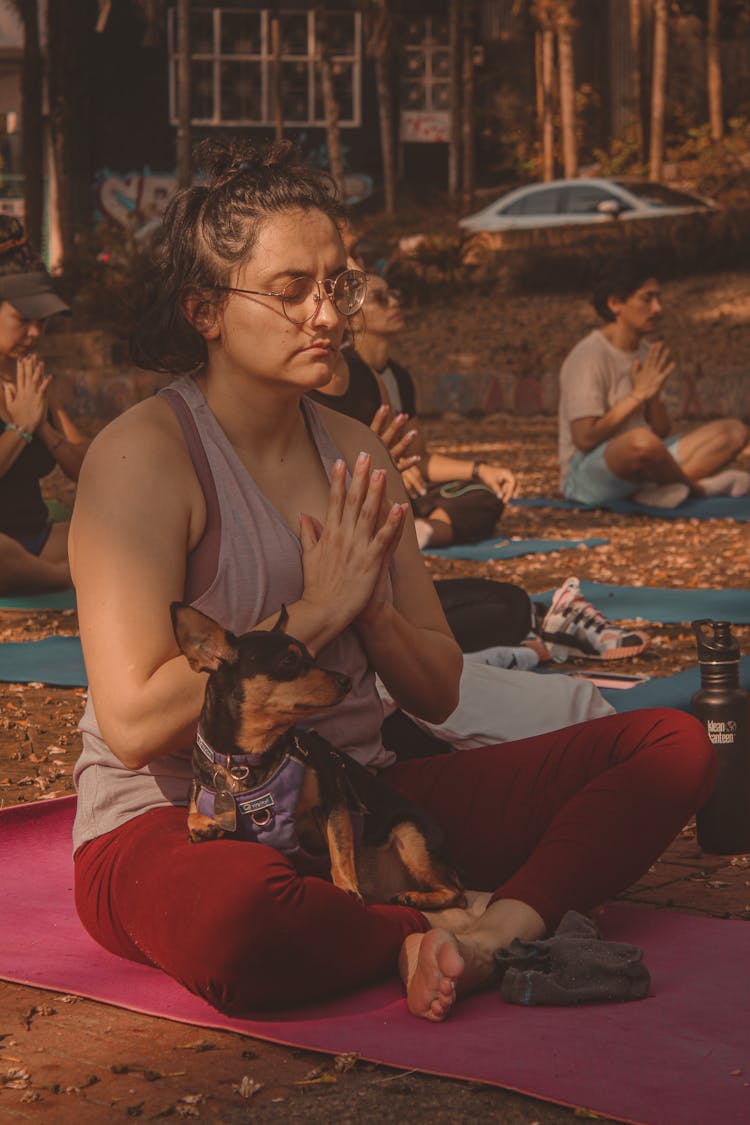 Woman Doing Yoga With Her Pet Dog