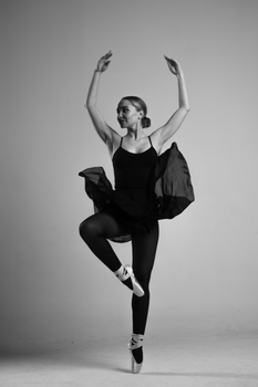 Ballet dancer in elegant pose during a studio shoot, captured in black and white.