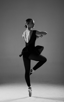 Captivating black and white portrait of a ballerina dancing gracefully in the studio.