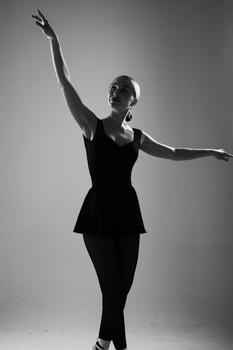 Graceful ballet dancer posing in black and white, showcasing elegance and poise.