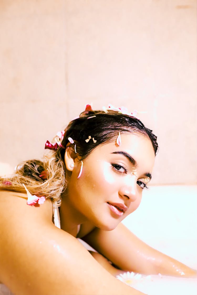 A Woman Taking Bath With Petals