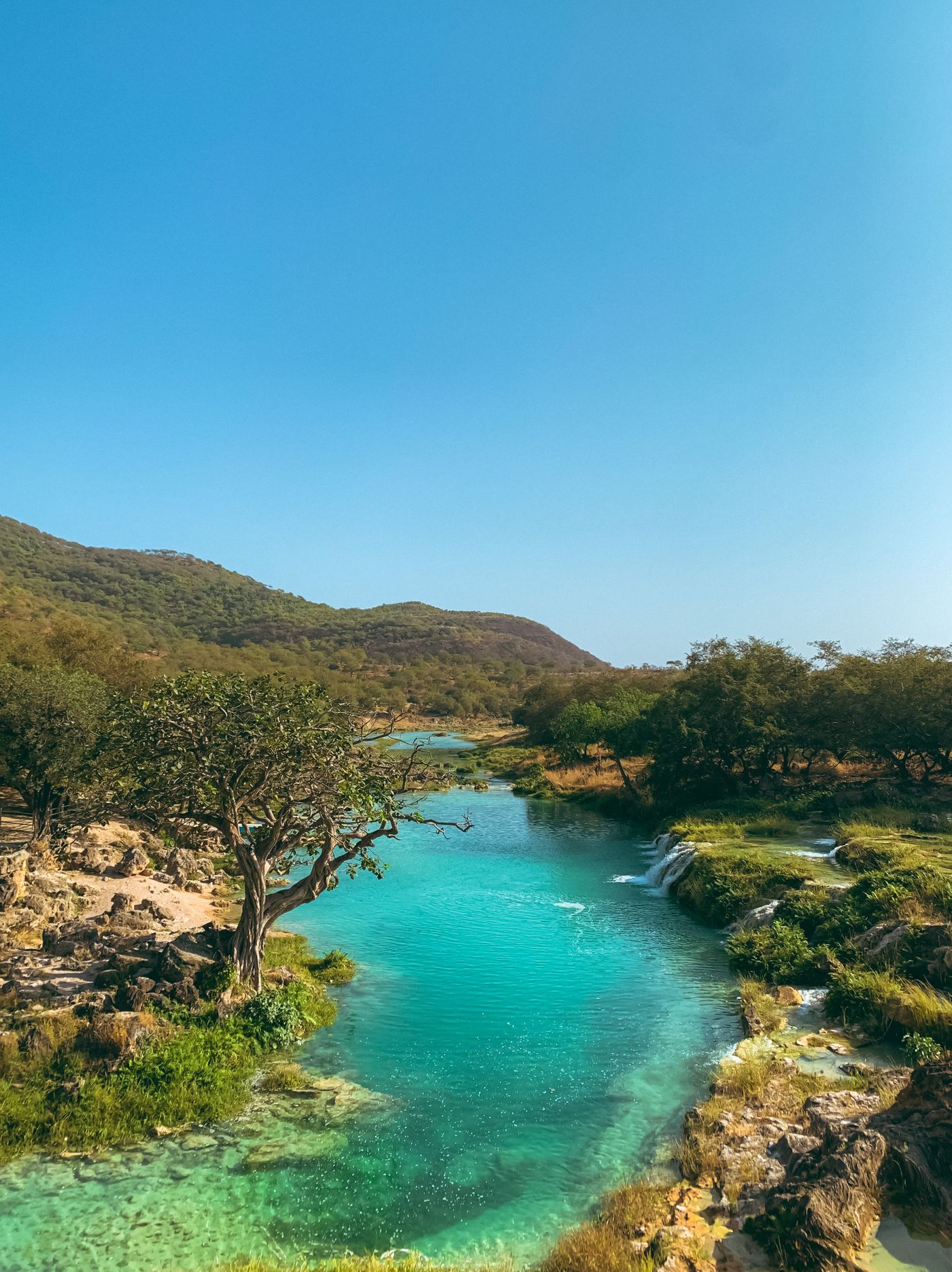 Darbat Lake waterfall, Salalah, Oman — one of the stops on LaneTwelve Properties site tours
