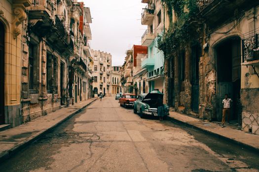 Explore this vintage street scene with classic cars in a historic old town setting.