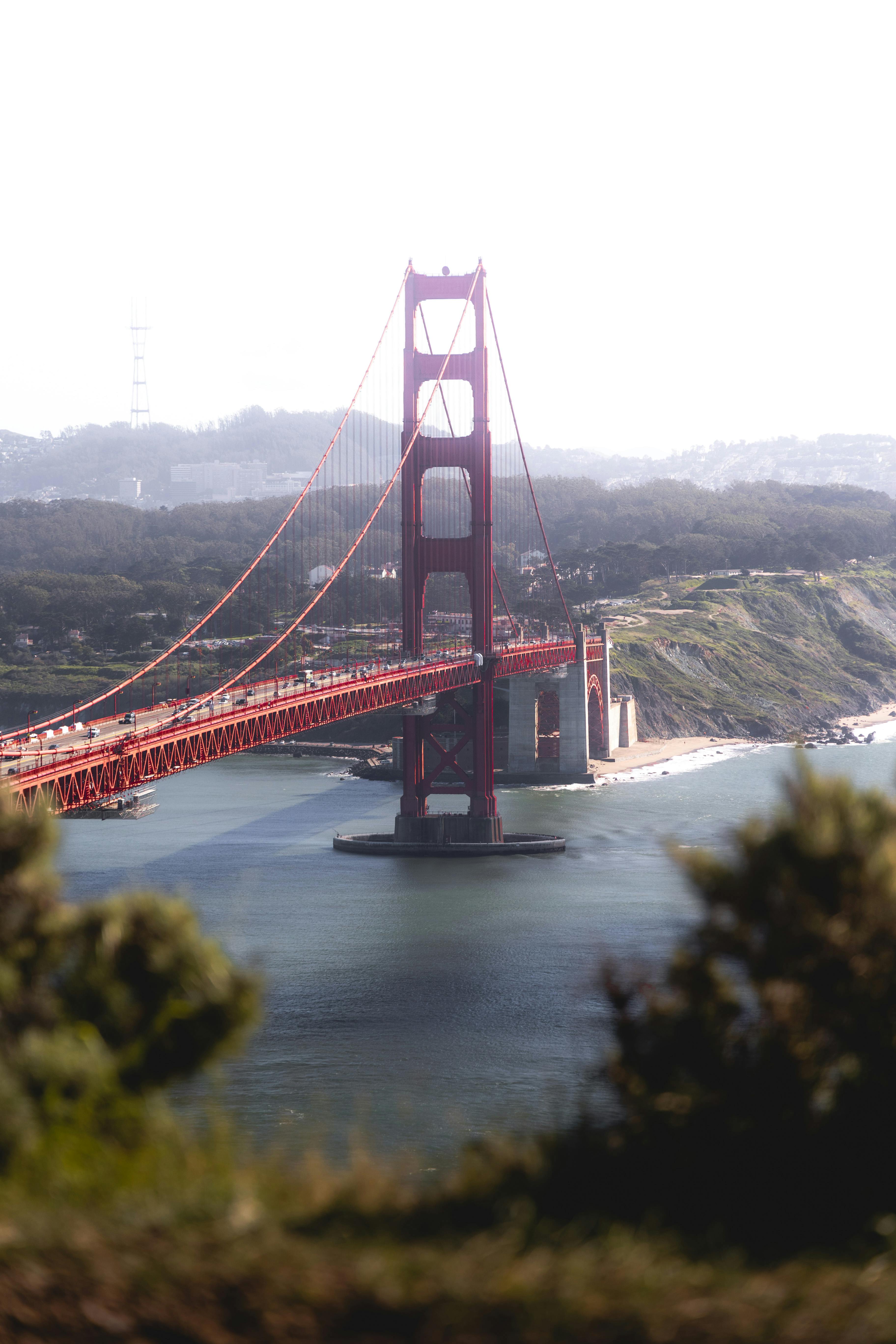 view of big red span of bridge over river