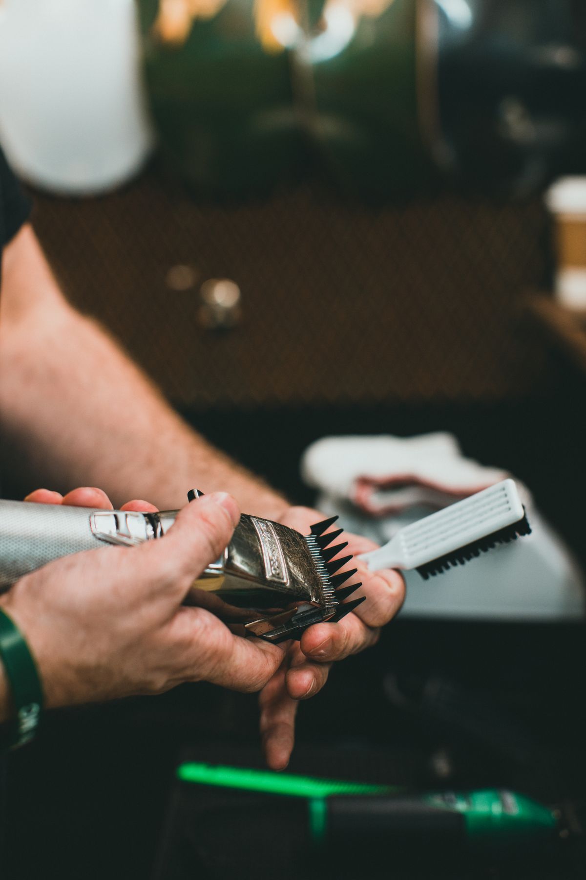 Cleaning hair clipper blades with a brush
