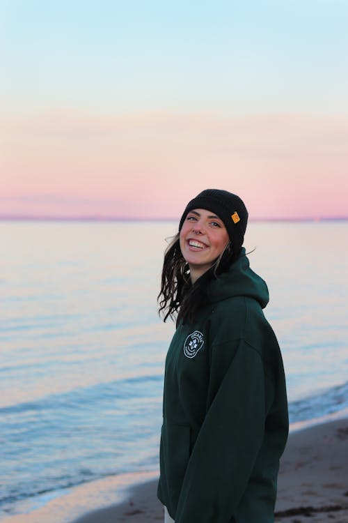 A Woman Wearing a Hoodie Sweater on the Beach